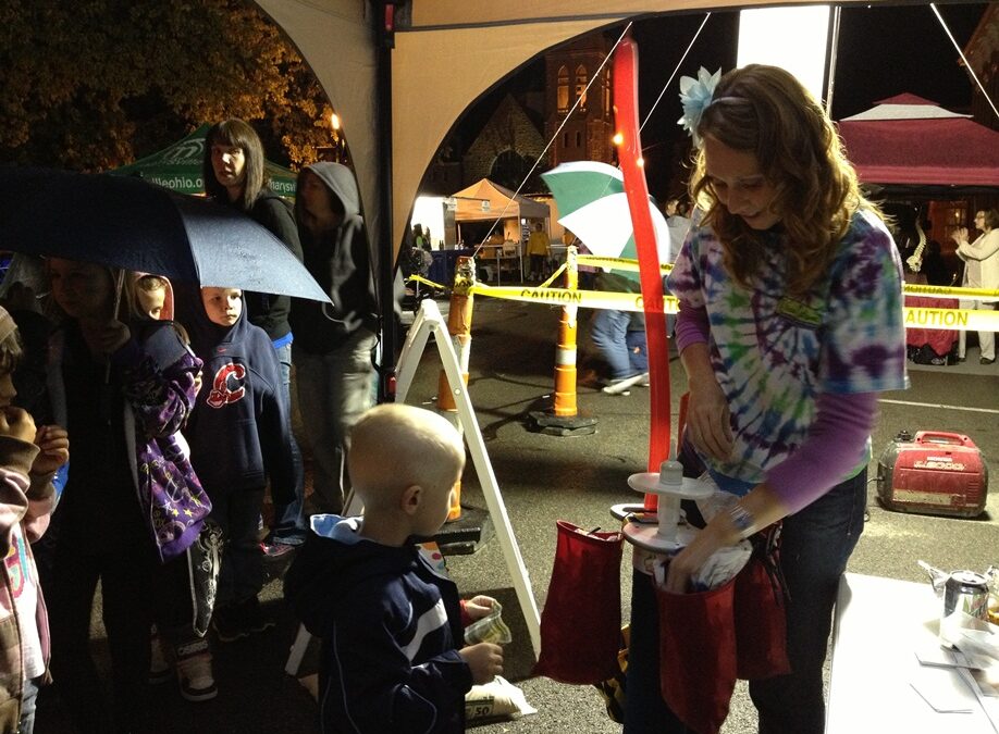 Erica making Baloon art for Marysville kids during Uptown Friday Nights